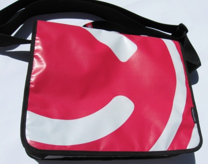 A recycled laptop bag made from Powershop's Electricity vs Power billboard campaign.
